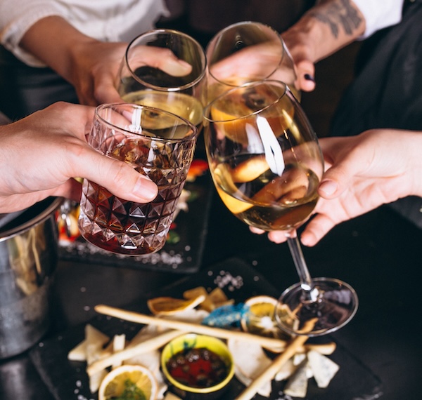 Male and female hands close up with cocktails